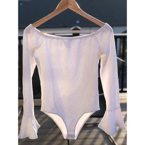 Off the shoulder white body suit.